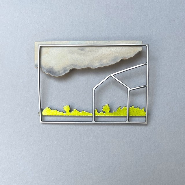 Framed landscape brooch with a house outline, cloud and yellow-green trees